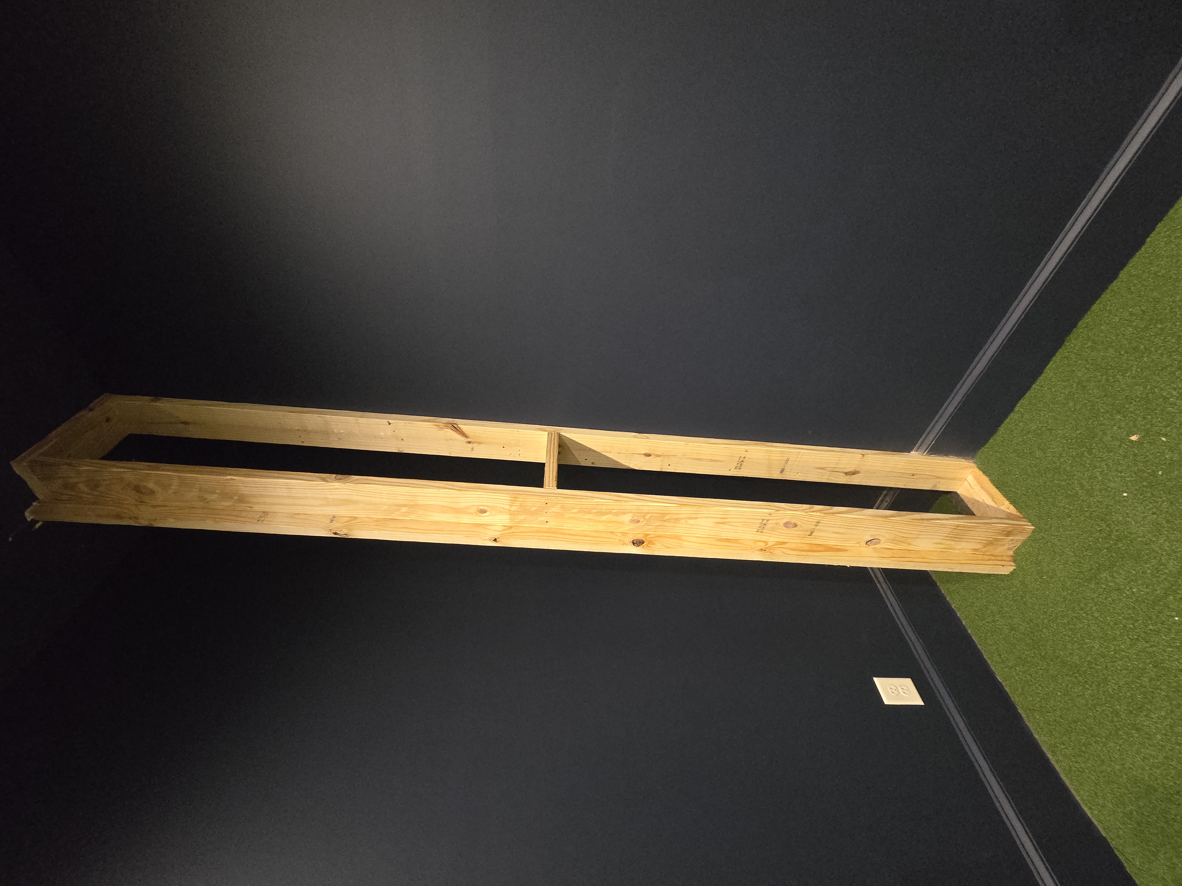 Custom wood framing built for a residential golf simulator screen wall
