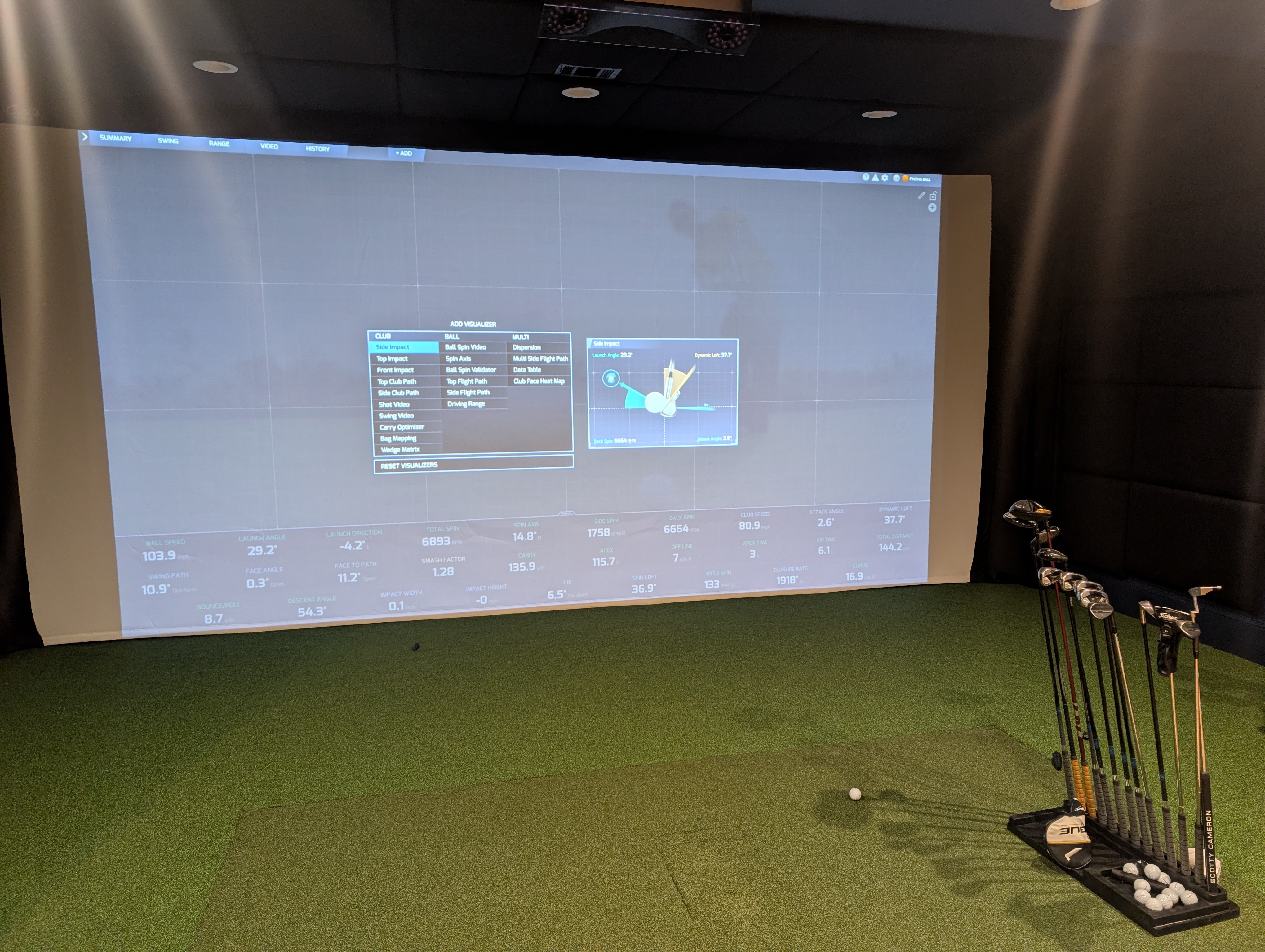 Completed custom golf simulator with launch data displayed across the impact screen